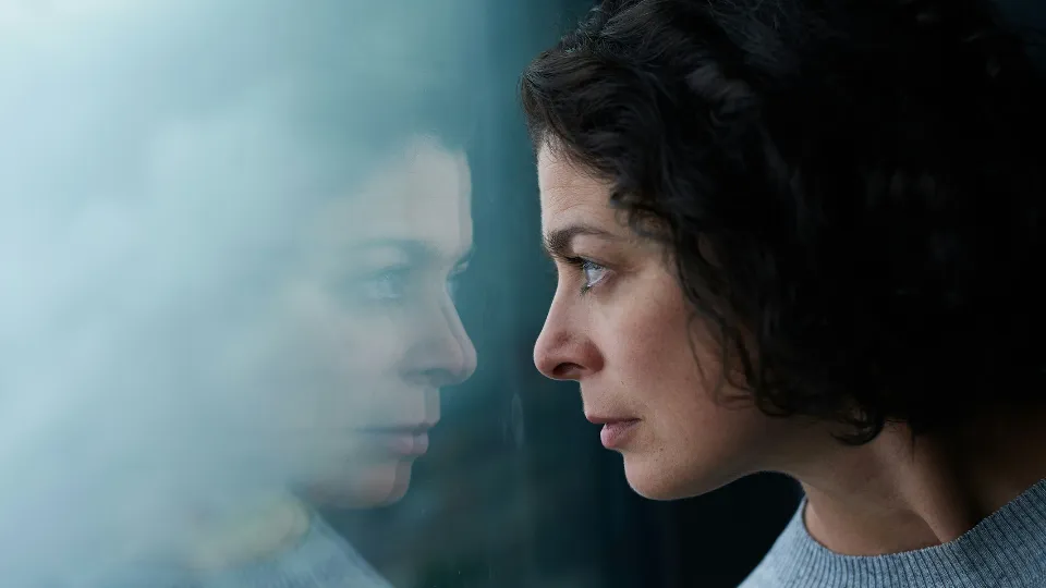 woman looking through window